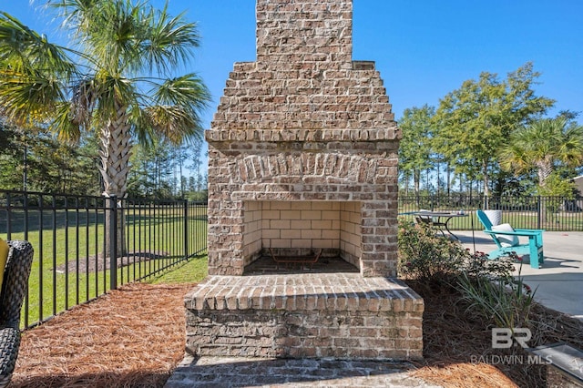 view of patio featuring an outdoor brick fireplace