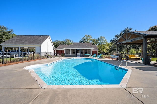 view of swimming pool with a gazebo, a patio area, and a sunroom