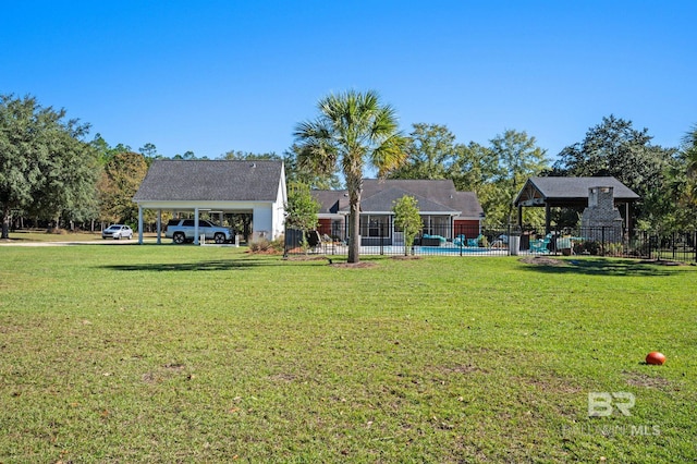 view of yard featuring a swimming pool and a carport