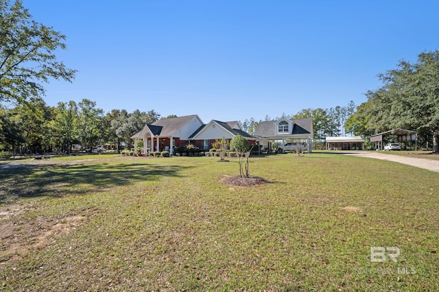 view of front of house with a front lawn and a carport