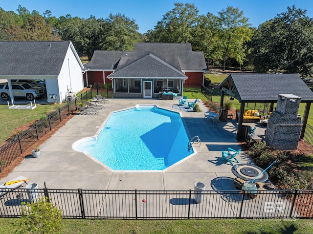 view of swimming pool with a sunroom, a patio area, and a gazebo