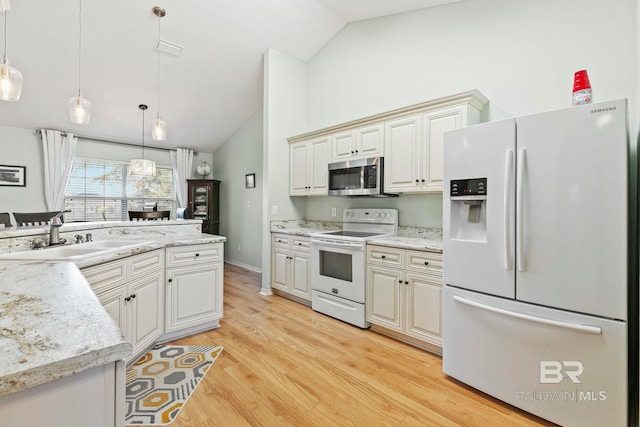 kitchen with white appliances, high vaulted ceiling, sink, light hardwood / wood-style flooring, and decorative light fixtures