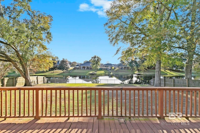 wooden deck featuring a lawn and a water view