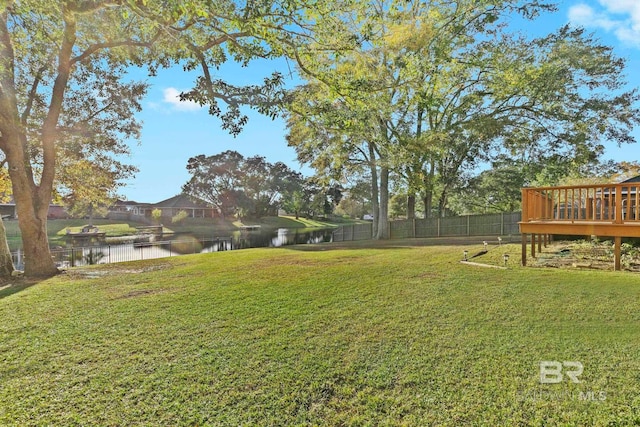 view of yard featuring a deck with water view