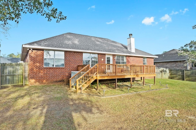 back of property with a lawn and a wooden deck