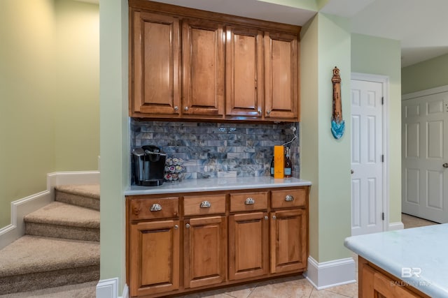 630 Lemoyne Dr Unit 8D, Dauphin Island, AL 36528 - bar featuring tasteful backsplash, light tile patterned flooring, baseboards, and stairway