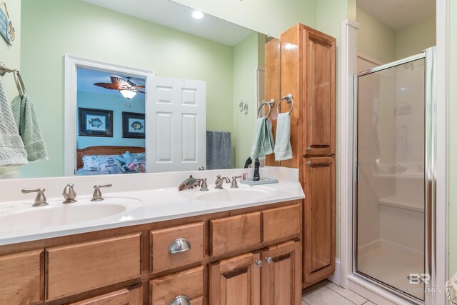 630 Lemoyne Dr Unit 8D, Dauphin Island, AL 36528 - bathroom featuring double vanity, ensuite bath, a sink, and a stall shower