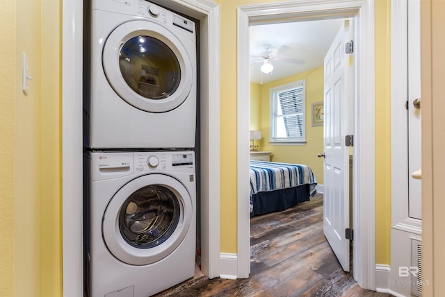 630 Lemoyne Dr Unit 8D, Dauphin Island, AL 36528 - washroom featuring baseboards, stacked washer and clothes dryer, dark wood-style floors, laundry area, and ceiling fan