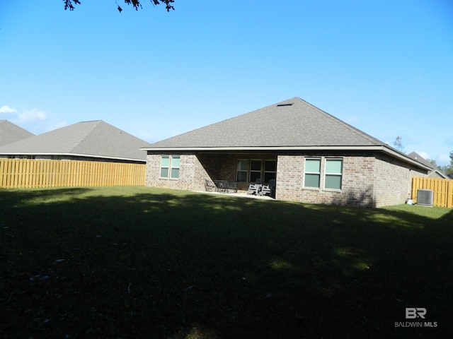 rear view of house featuring central AC, a yard, and a patio