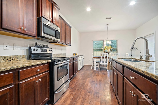 kitchen featuring light stone countertops, dark hardwood / wood-style flooring, stainless steel appliances, and sink