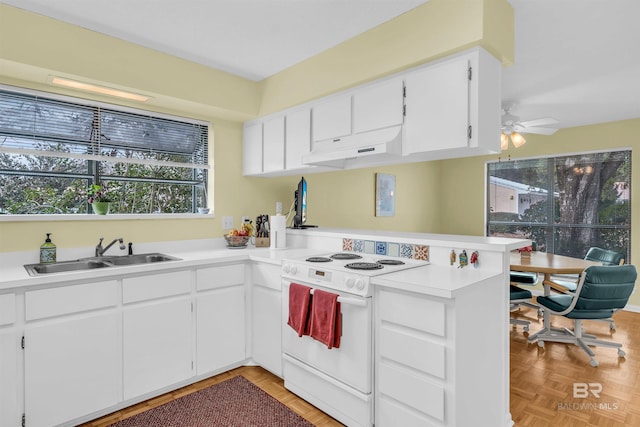2277 Oyster Bay Ln Unit 502, Gulf Shores, AL 36542 - kitchen featuring a peninsula, under cabinet range hood, light countertops, a sink, and white electric stove
