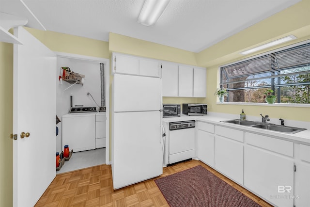 2277 Oyster Bay Ln Unit 502, Gulf Shores, AL 36542 - kitchen featuring a sink, white appliances, white cabinets, and washer and clothes dryer
