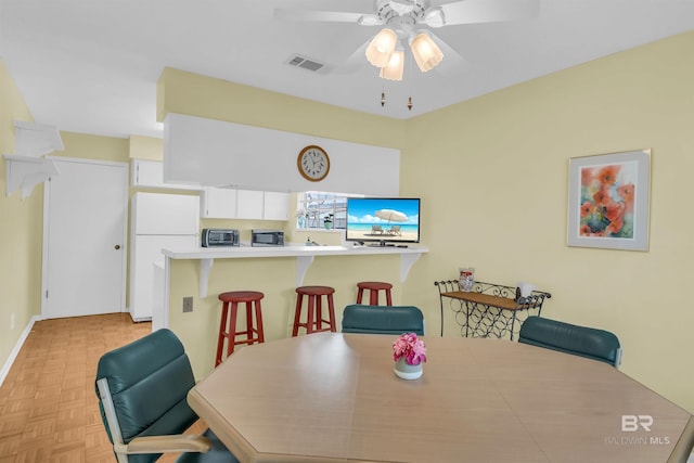 2277 Oyster Bay Ln Unit 502, Gulf Shores, AL 36542 - dining room featuring visible vents, ceiling fan, a toaster, and baseboards