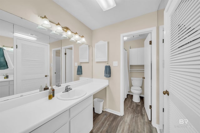 2277 Oyster Bay Ln Unit 502, Gulf Shores, AL 36542 - full bathroom with a closet, baseboards, toilet, vanity, and wood finished floors