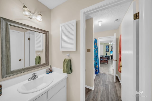 2277 Oyster Bay Ln Unit 502, Gulf Shores, AL 36542 - bathroom with wood finished floors, vanity, baseboards, and visible vents