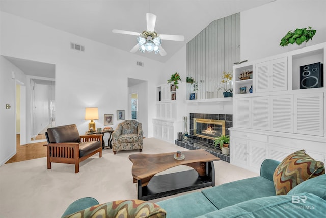 2277 Oyster Bay Ln Unit 502, Gulf Shores, AL 36542 - living room with a tiled fireplace, visible vents, ceiling fan, and high vaulted ceiling