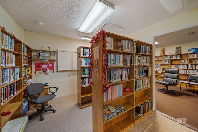 2277 Oyster Bay Ln Unit 502, Gulf Shores, AL 36542 - carpeted home office featuring a textured ceiling, visible vents, and bookshelves