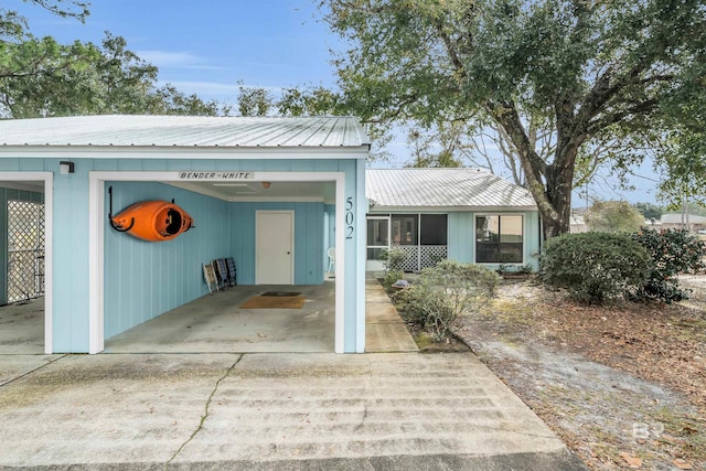 2277 Oyster Bay Ln Unit 502, Gulf Shores, AL 36542 - view of front of home with concrete driveway, metal roof, and an attached carport