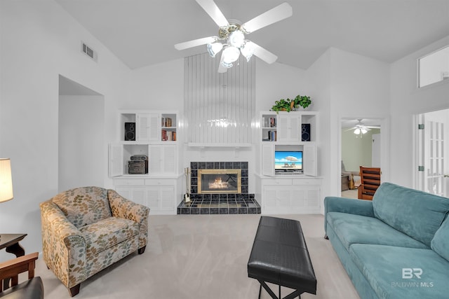 2277 Oyster Bay Ln Unit 502, Gulf Shores, AL 36542 - living room with a tiled fireplace, visible vents, ceiling fan, high vaulted ceiling, and carpet
