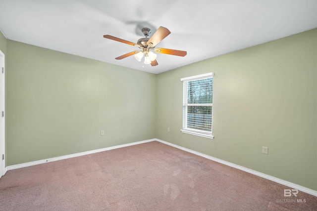 spare room with carpet floors and ceiling fan