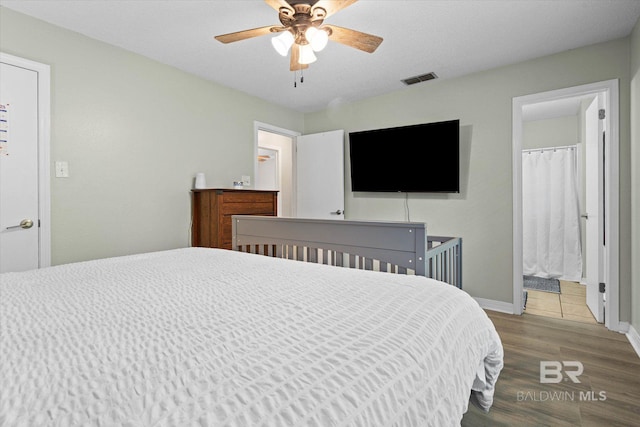9340 Burnt Tree Dr, Mobile, AL 36695 - bedroom featuring wood finished floors, baseboards, ceiling fan, and ensuite bathroom