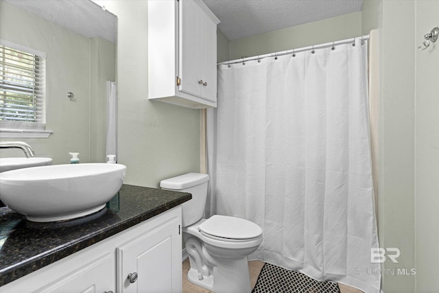 9340 Burnt Tree Dr, Mobile, AL 36695 - full bath with vanity, a textured ceiling, toilet, tile patterned floors, and curtained shower