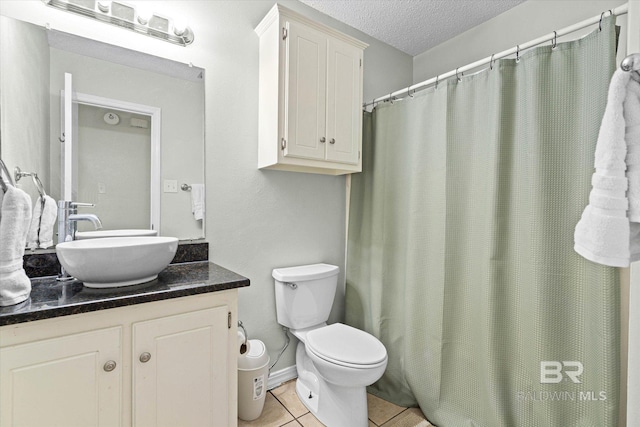 9340 Burnt Tree Dr, Mobile, AL 36695 - full bath with vanity, toilet, tile patterned floors, a textured ceiling, and a shower with curtain