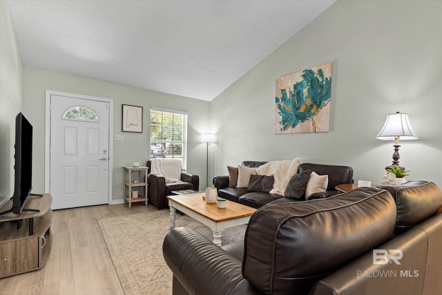 9340 Burnt Tree Dr, Mobile, AL 36695 - living room featuring lofted ceiling, light wood-style flooring, and baseboards