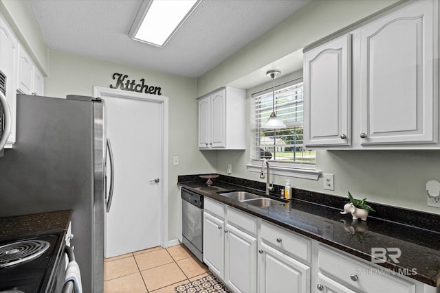 9340 Burnt Tree Dr, Mobile, AL 36695 - kitchen featuring stainless steel appliances, a sink, white cabinets, dark stone counters, and decorative light fixtures