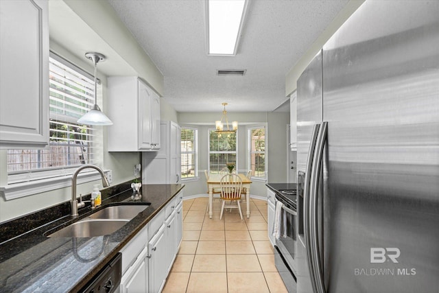 9340 Burnt Tree Dr, Mobile, AL 36695 - kitchen with appliances with stainless steel finishes, a sink, white cabinets, light tile patterned floors, and decorative light fixtures