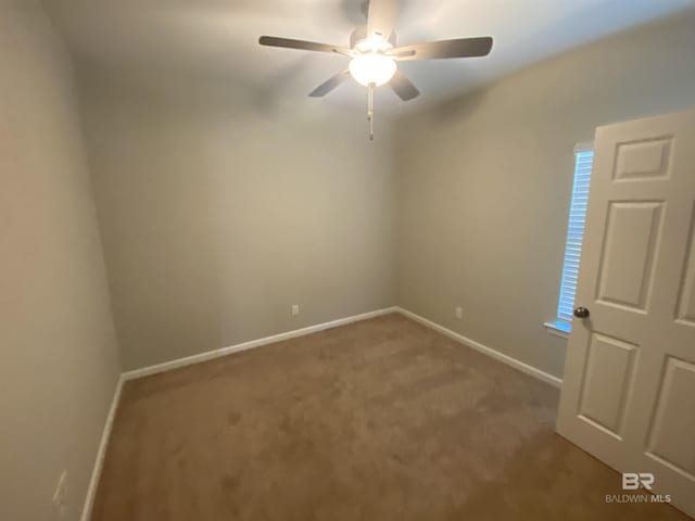 empty room with ceiling fan and carpet