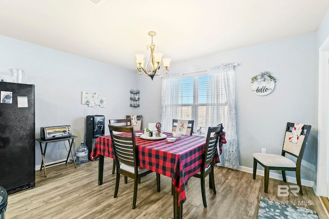 dining room with a chandelier and hardwood / wood-style flooring