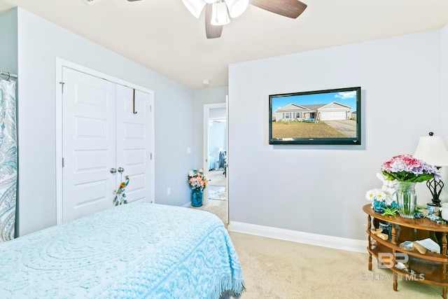 carpeted bedroom featuring a closet and ceiling fan