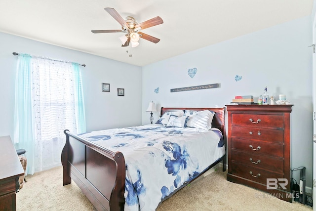 bedroom with ceiling fan and light carpet