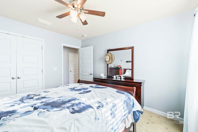 carpeted bedroom featuring ceiling fan and a closet