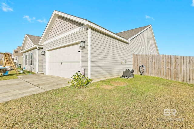 view of side of property with a lawn and a garage