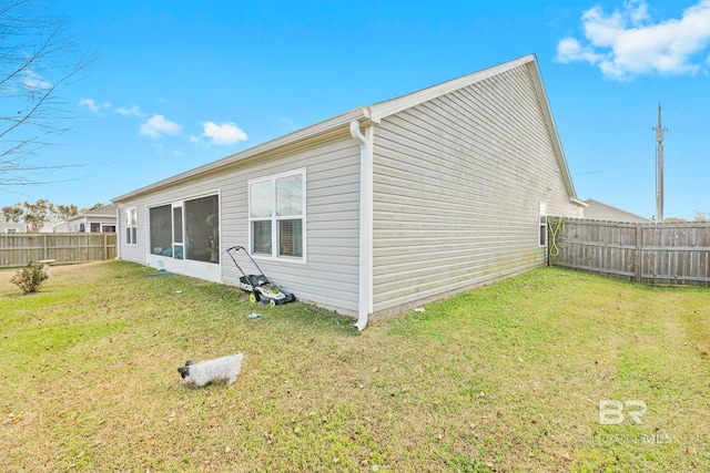 view of side of property with a lawn