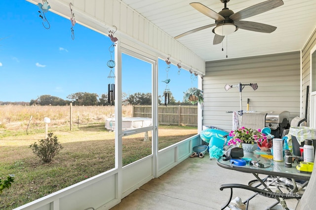 sunroom / solarium featuring ceiling fan