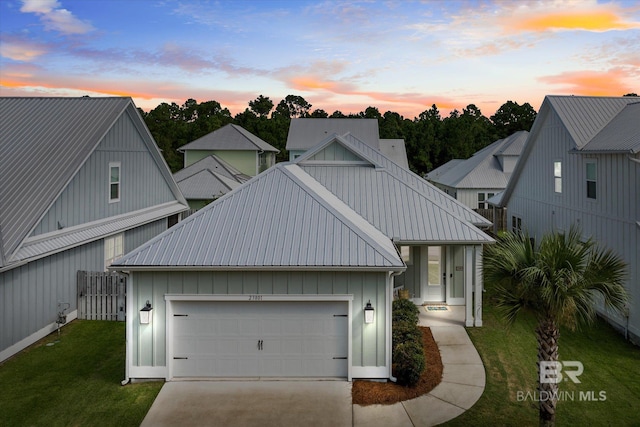 view of front facade featuring a garage and a lawn