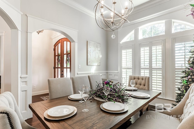 dining room with wood-type flooring, crown molding, and a chandelier