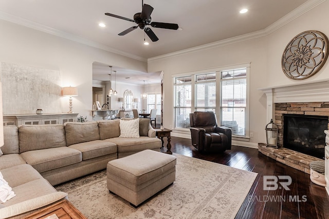 living room with a fireplace, ceiling fan, dark hardwood / wood-style flooring, and crown molding