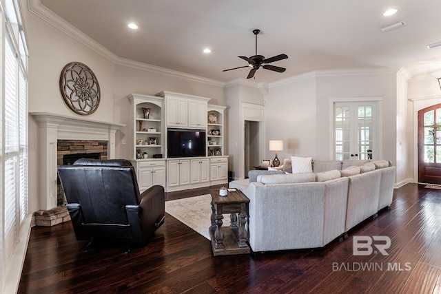 living room with a fireplace, ceiling fan, dark hardwood / wood-style flooring, and ornamental molding