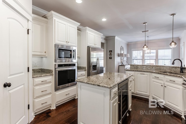 kitchen featuring sink, white cabinetry, stainless steel appliances, and beverage cooler