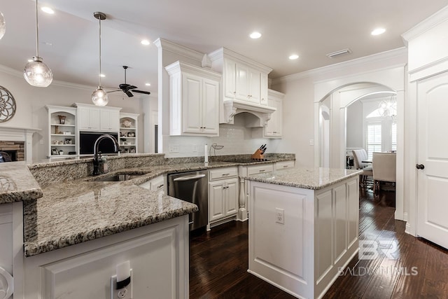 kitchen with dishwasher, a center island, white cabinets, ceiling fan, and decorative light fixtures