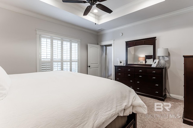 bedroom with ceiling fan, a raised ceiling, crown molding, and light carpet