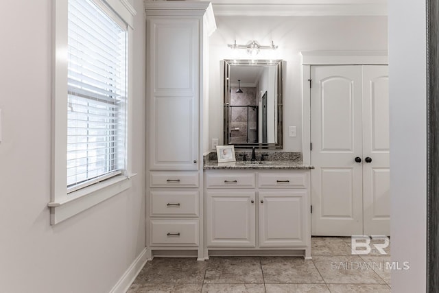 bathroom with crown molding and vanity