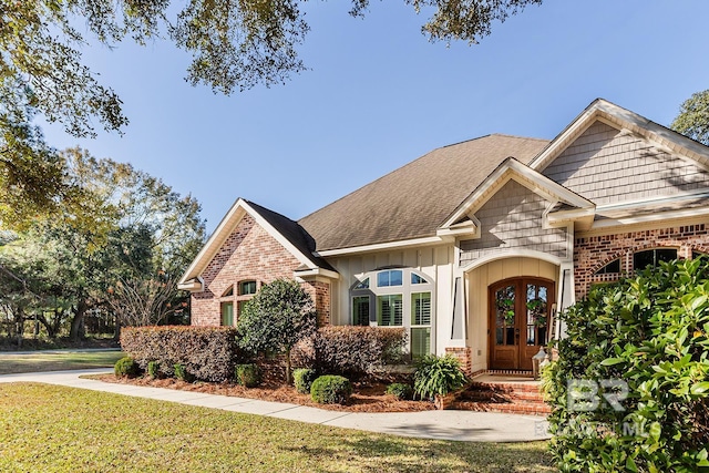 view of front of house featuring a front yard and french doors