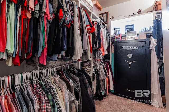 walk in closet with carpet flooring