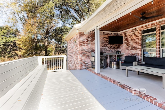 deck featuring an outdoor hangout area, area for grilling, and ceiling fan