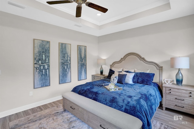12753 Shoshoney Cir, Fairhope, AL 36532 - bedroom featuring visible vents, a ceiling fan, a tray ceiling, wood finished floors, and baseboards